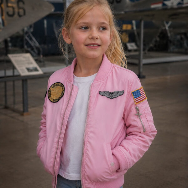 121432 23 08 De Kinder MA-1 Flight Jacket in het roze is de perfecte combinatie van stoer en schattig voor jonge avonturiers. Geïnspireerd op de klassieke bomberjas, heeft deze jacket vrolijke geborduurde emblemen zoals 'Women Airforce', 'Top Gun' en de Amerikaanse vlag. Met praktische details zoals vliegtuigvormige ritsen en een mouwvakje met pennenvakje, is deze jas niet alleen trendy maar ook functioneel. Gemaakt van 100% nylon aan de buitenkant en 100% polyester aan de binnenkant, biedt deze jas comfort en stijl.