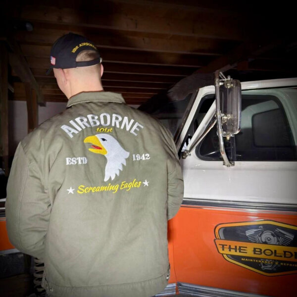 129806 11 09 De Heritage Airborne jacket is geïnspireerd op het iconische Worker Jacket en beschikt over het legendarische Airborne 101st logo. Deze stijlvolle jas is gemaakt van 100% katoen met een comfortabele nylon voering, waardoor hij perfect is als tussenjas voor dagelijks gebruik. Met een relaxed fit, verstelbare mouwen en taille, en praktische zakken combineert deze jas functionaliteit met een vintage uitstraling. Ideaal voor zowel werk als vrije tijd.